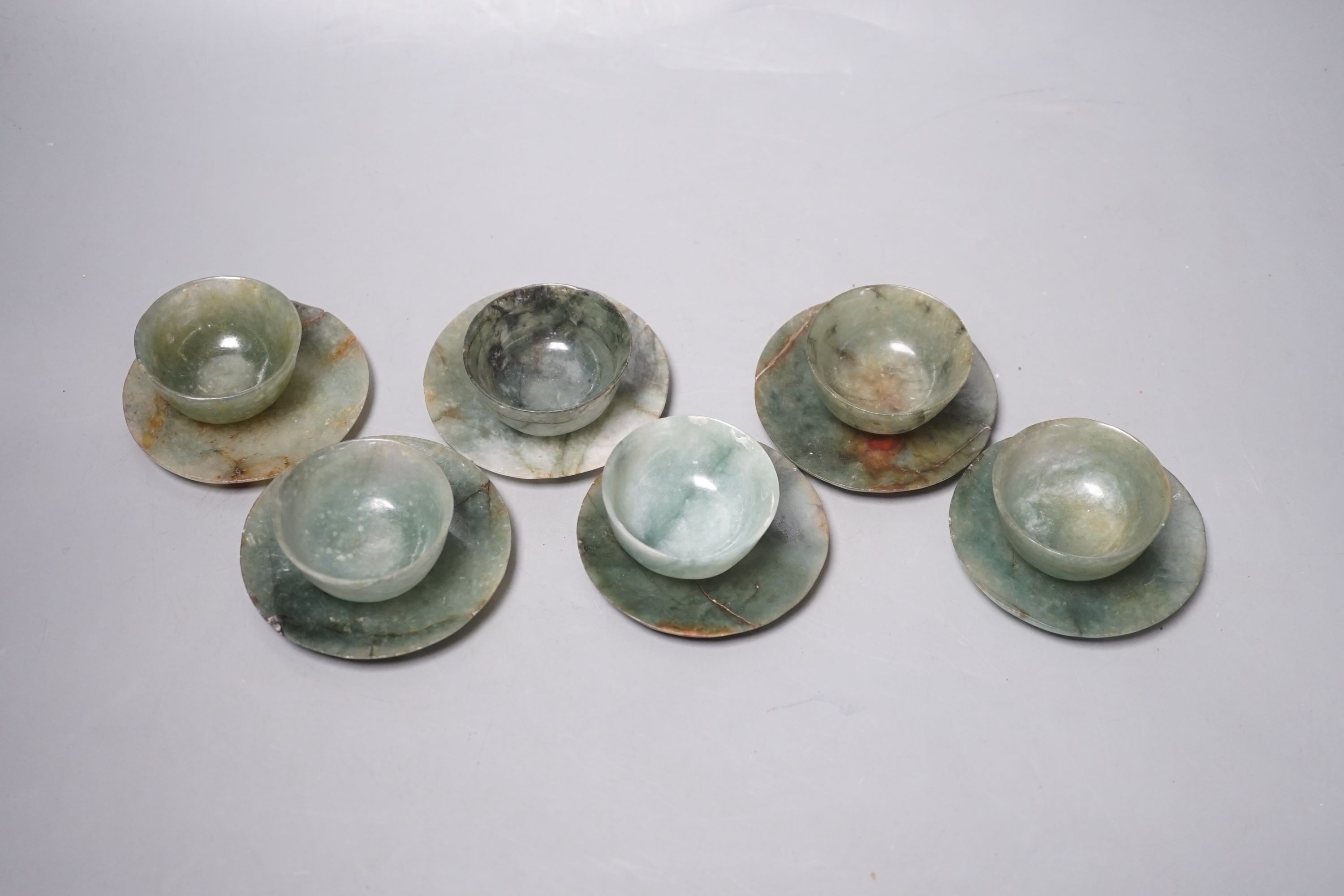 A set of six Chinese moss agate tea bowls and six saucers, engraved Qianlong mark, 19th century, saucers 8cm diameter